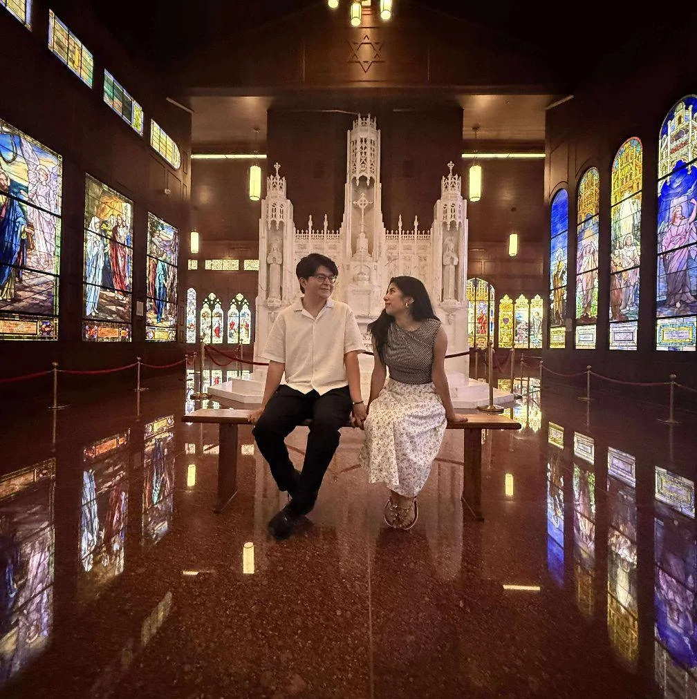Sam and Andy sitting together in a chapel in Japan